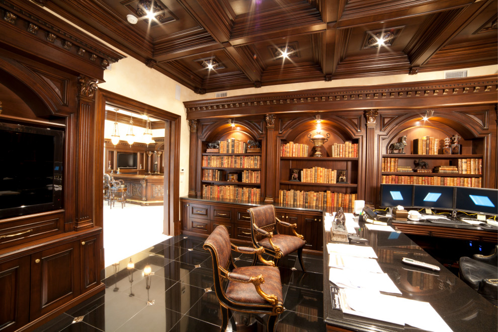 This is an example of a mid-sized traditional home office in New York with a library, white walls, ceramic floors, no fireplace, a built-in desk, black floor, coffered and wood walls.