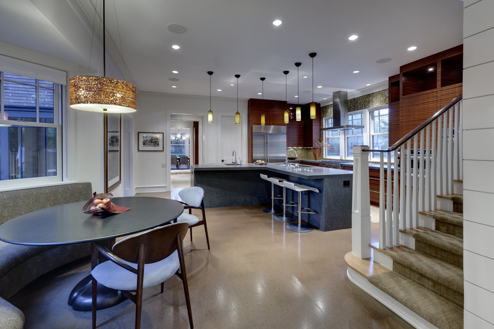 This is an example of a contemporary eat-in kitchen in Dallas with flat-panel cabinets, medium wood cabinets and stainless steel appliances.