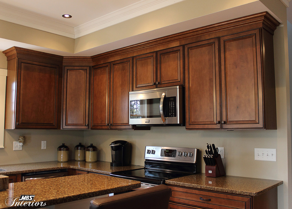 Transitional l-shaped kitchen photo in Columbus with an undermount sink, recessed-panel cabinets, medium tone wood cabinets, quartz countertops, stainless steel appliances and an island