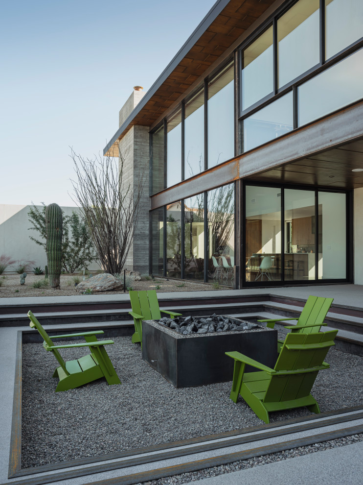 На фото: двухэтажный частный загородный дом в стиле модернизм с облицовкой из бетона, плоской крышей и металлической крышей