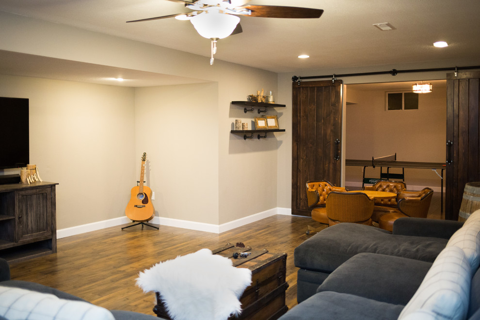 Mid-sized mountain style underground medium tone wood floor basement photo in St Louis with beige walls and no fireplace