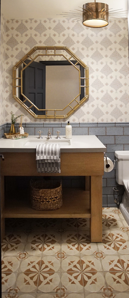 Design ideas for a transitional powder room in Phoenix with blue tile, terra-cotta tile, multi-coloured walls, terra-cotta floors, an undermount sink, multi-coloured floor, grey benchtops and wallpaper.