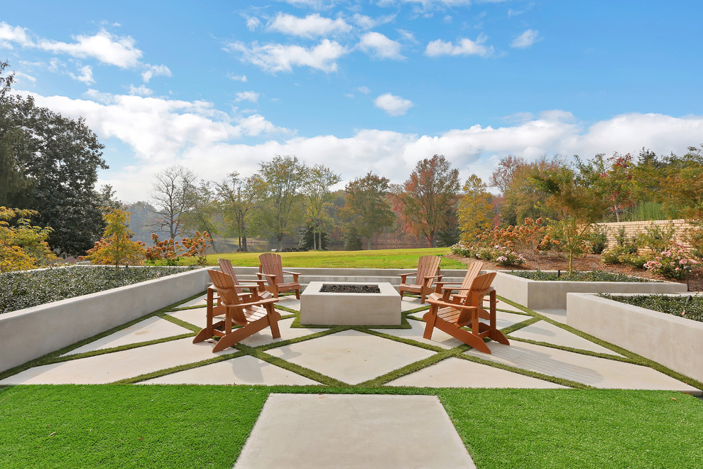 Large midcentury backyard full sun garden in Other with a fire feature and concrete pavers.