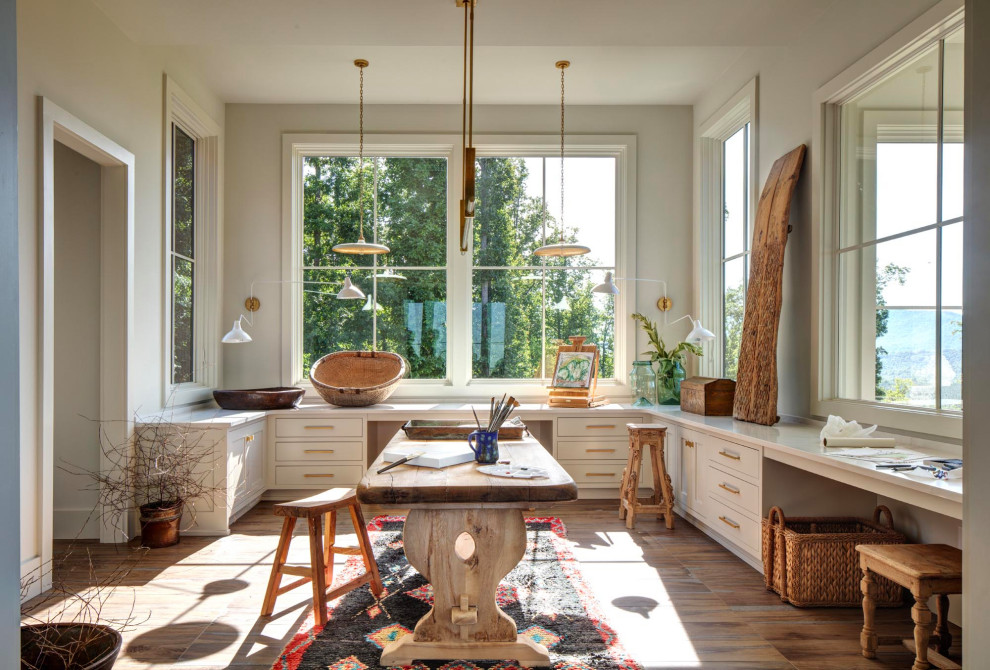Craft room - huge transitional built-in desk porcelain tile and brown floor craft room idea in Richmond with beige walls