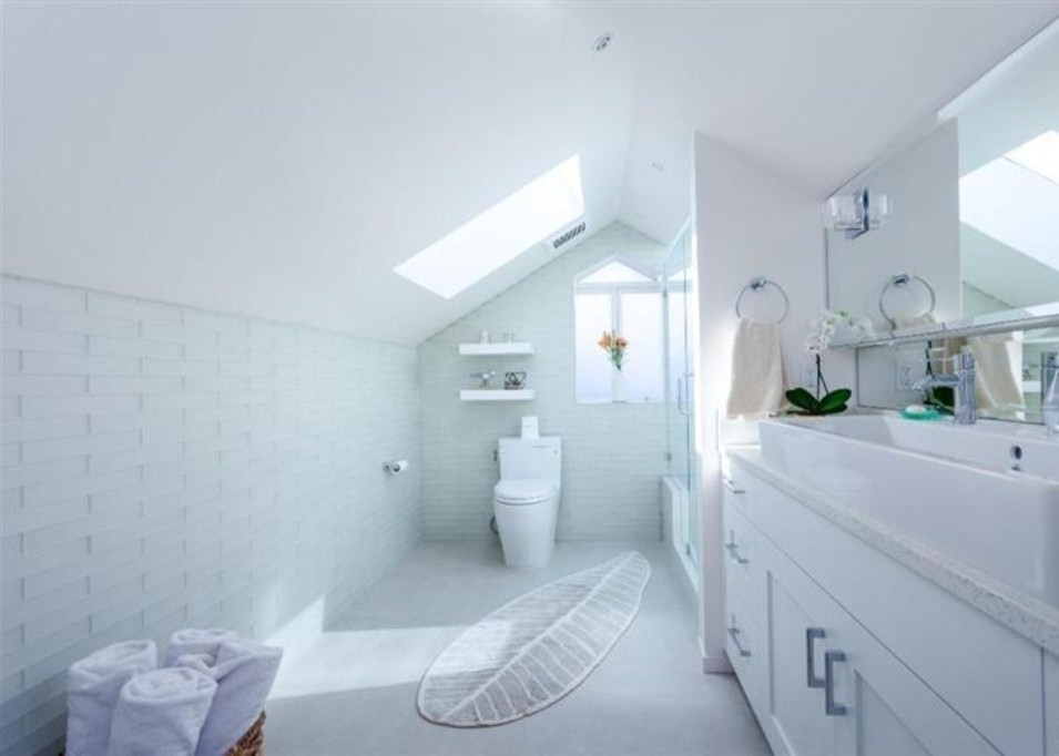 Photo of a mid-sized transitional 3/4 bathroom in San Francisco with white cabinets, green tile, glass tile, porcelain floors, recycled glass benchtops, recessed-panel cabinets, an alcove shower, a two-piece toilet, white walls and a trough sink.
