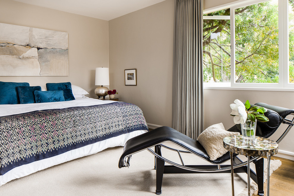 Contemporary bedroom in San Francisco with beige walls and medium hardwood floors.