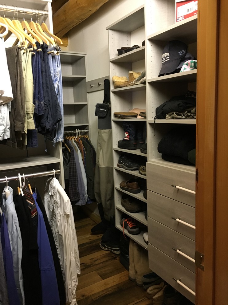 Inspiration for a mid-sized transitional gender-neutral dark wood floor and brown floor walk-in closet remodel in Denver with flat-panel cabinets and white cabinets