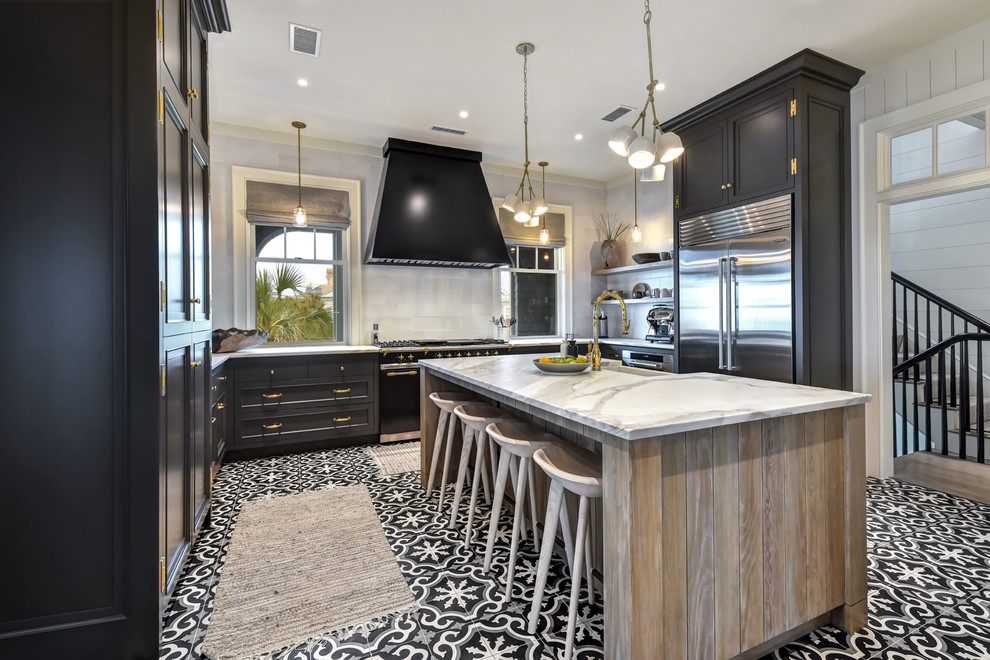 Photo of a mid-sized country u-shaped separate kitchen in Charleston with a farmhouse sink, recessed-panel cabinets, black cabinets, white splashback, stainless steel appliances, with island, multi-coloured floor, white benchtop, marble benchtops, subway tile splashback and cement tiles.