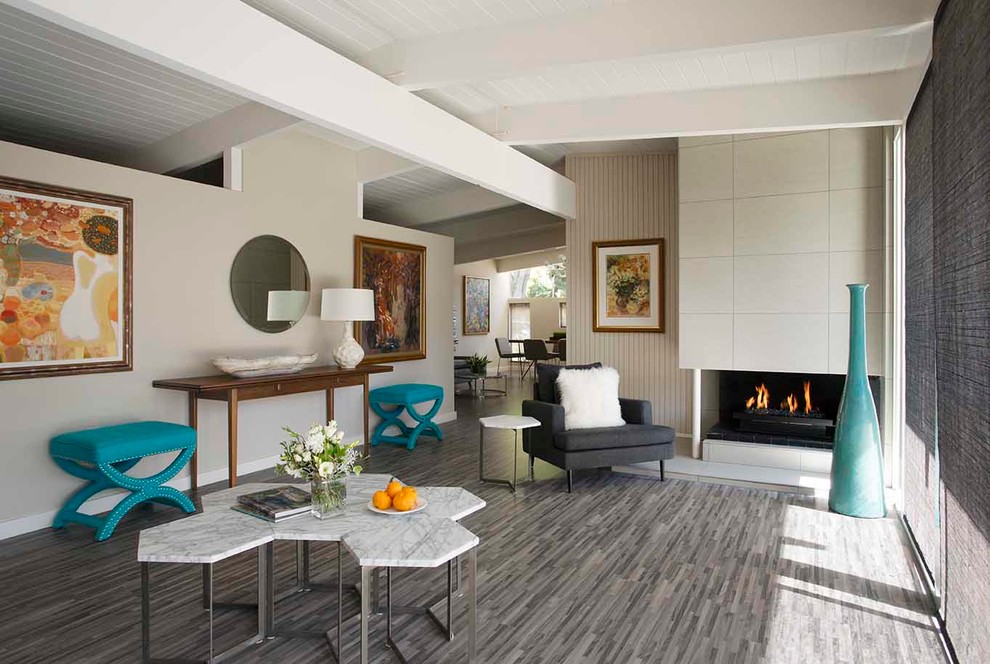 Inspiration for a mid-sized midcentury open concept living room in San Francisco with grey walls, light hardwood floors, a corner fireplace, a concrete fireplace surround and no tv.