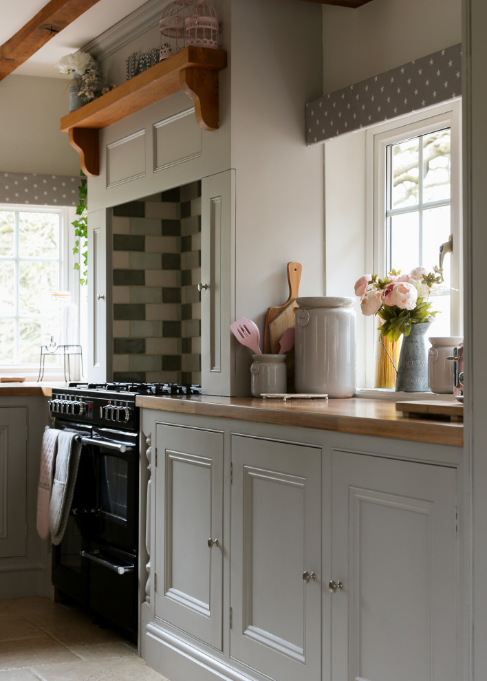 Design ideas for a medium sized country kitchen/diner in Surrey with shaker cabinets, grey cabinets, wood worktops, multi-coloured splashback, ceramic splashback, integrated appliances, an island and brown worktops.