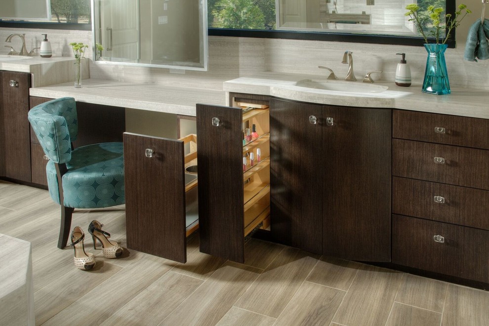 Inspiration for a large transitional master bathroom in Sacramento with flat-panel cabinets, medium wood cabinets, a drop-in tub, gray tile, white tile, stone slab, beige walls, solid surface benchtops, a double shower, a two-piece toilet, porcelain floors and an undermount sink.