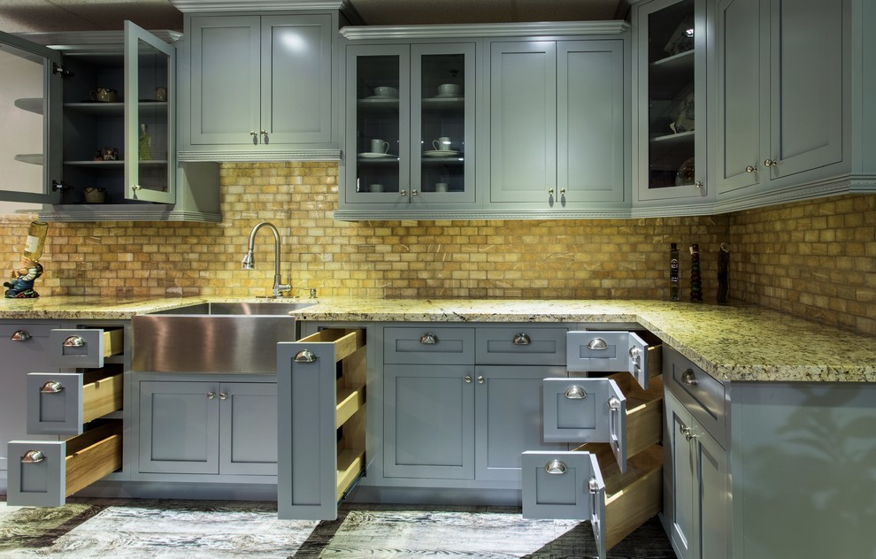 Large farmhouse l-shaped dark wood floor open concept kitchen photo in Los Angeles with a farmhouse sink, recessed-panel cabinets, gray cabinets, granite countertops, multicolored backsplash, stone tile backsplash, stainless steel appliances and no island