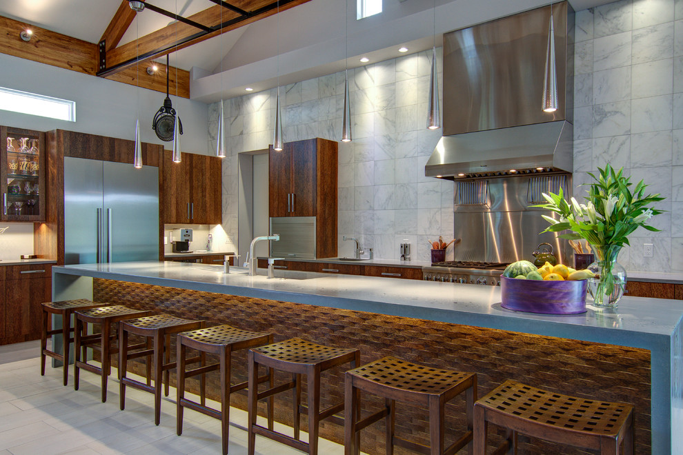 Large contemporary l-shaped open plan kitchen in Tampa with concrete benchtops, stainless steel appliances, flat-panel cabinets, dark wood cabinets, white splashback, an undermount sink, porcelain floors, with island and marble splashback.