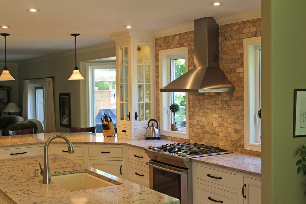 Open concept kitchen - mid-sized transitional u-shaped open concept kitchen idea with an undermount sink, beaded inset cabinets, white cabinets, granite countertops, gray backsplash, ceramic backsplash, stainless steel appliances, an island and beige countertops
