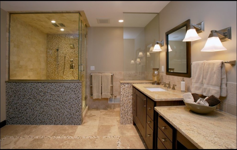 This is an example of a modern bathroom in Minneapolis with shaker cabinets, dark wood cabinets, a corner shower, beige tile, stone tile, beige walls, ceramic floors, an undermount sink, granite benchtops, beige floor and a hinged shower door.