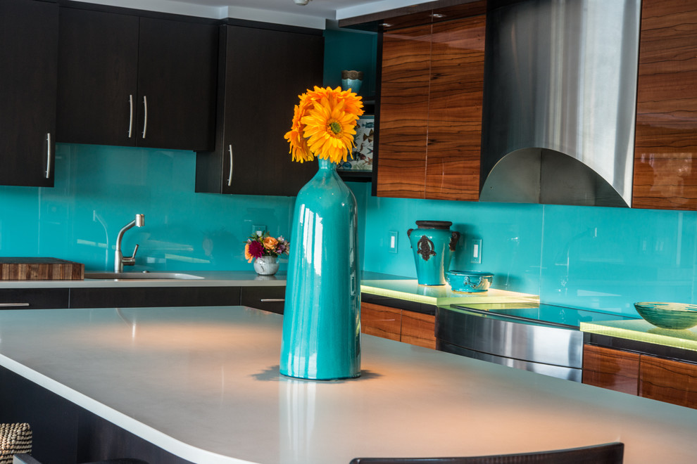 This is an example of a mid-sized contemporary l-shaped kitchen in Boston with an undermount sink, flat-panel cabinets, medium wood cabinets, quartzite benchtops, blue splashback, glass sheet splashback, stainless steel appliances and with island.