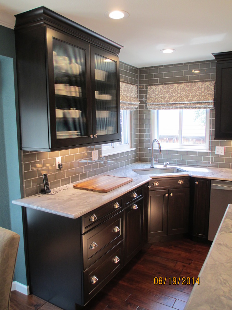 Example of a mid-sized transitional u-shaped dark wood floor kitchen design in Denver with an undermount sink, shaker cabinets, dark wood cabinets, marble countertops, gray backsplash, subway tile backsplash, stainless steel appliances and an island
