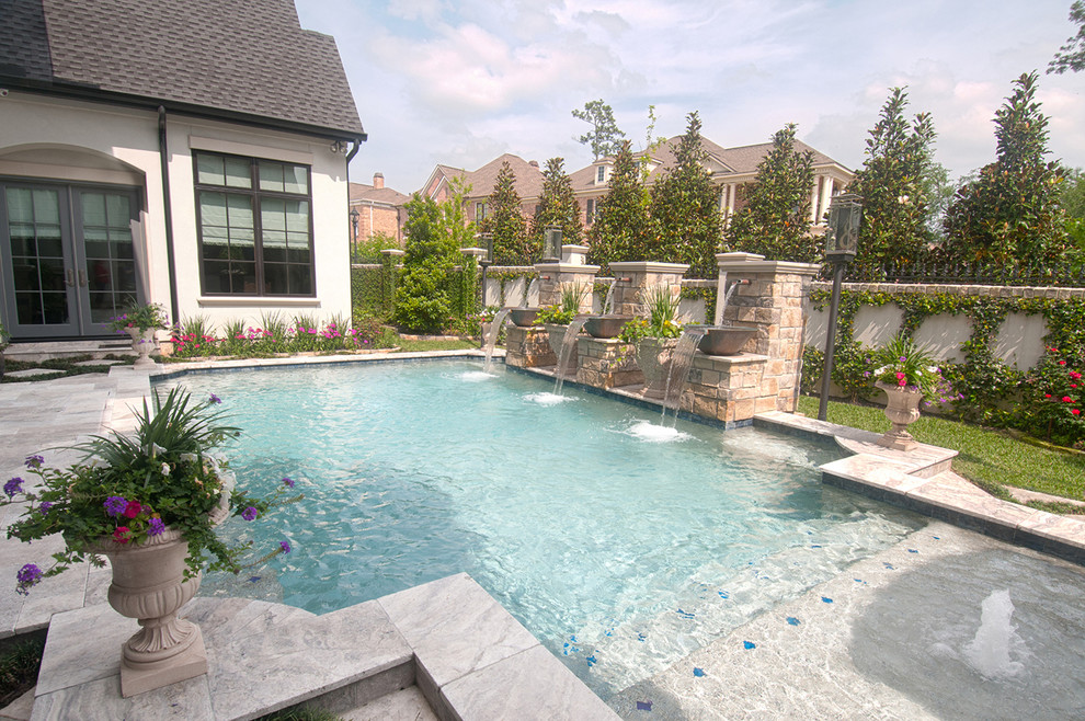 Large traditional courtyard rectangular pool in Houston with decking.