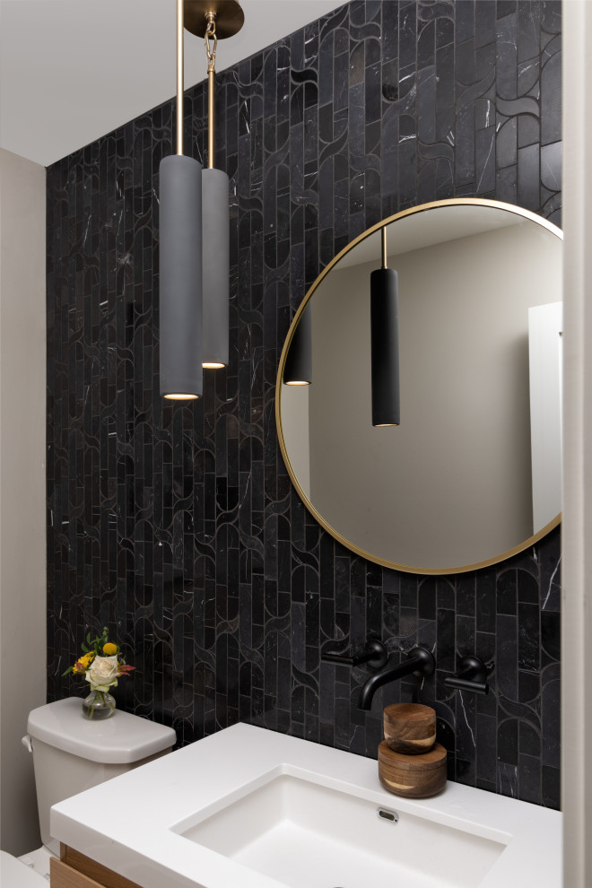 Design ideas for a small powder room in Kansas City with flat-panel cabinets, light wood cabinets, a two-piece toilet, black tile, marble, grey walls, light hardwood floors, an undermount sink, engineered quartz benchtops, brown floor, white benchtops and a built-in vanity.