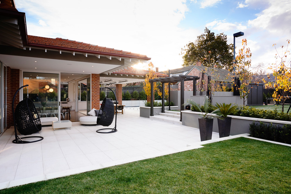 Contemporary patio in Melbourne with a pergola.