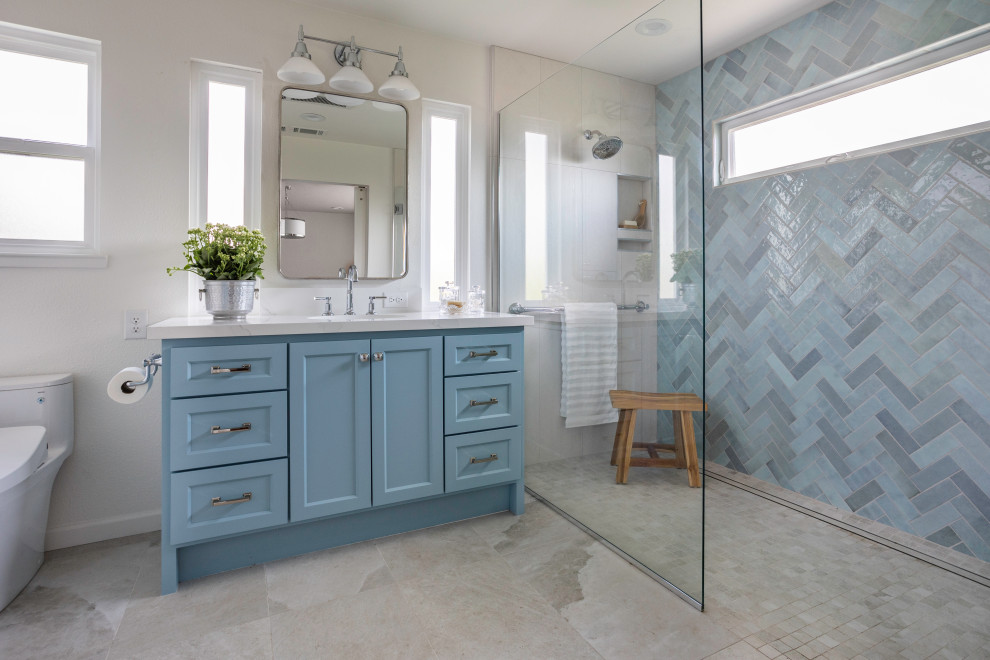 Photo of a classic bathroom in Sacramento with shaker cabinets, blue cabinets, a built-in shower, blue tiles, beige walls, a submerged sink, beige floors, an open shower, white worktops, a single sink and a built in vanity unit.