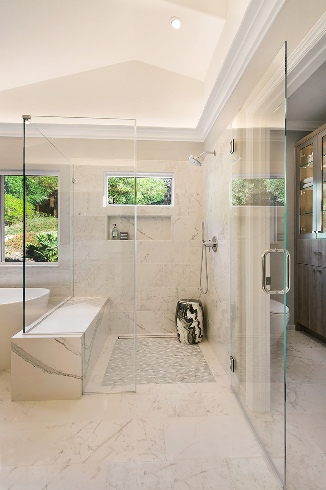 This is an example of a large contemporary master bathroom in San Francisco with flat-panel cabinets, medium wood cabinets, a freestanding tub, white tile, marble, marble benchtops and white benchtops.