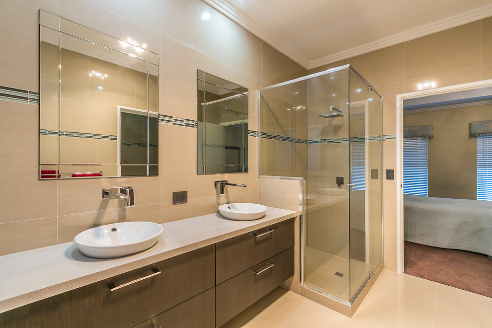 Mid-sized contemporary master bathroom in Perth with a vessel sink, flat-panel cabinets, dark wood cabinets, engineered quartz benchtops, a freestanding tub, a corner shower, a two-piece toilet, beige tile, porcelain tile, beige walls and porcelain floors.