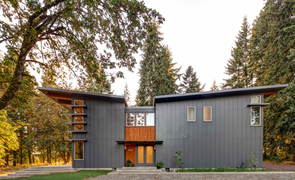 Design ideas for a contemporary two-storey grey exterior in Portland with a butterfly roof.