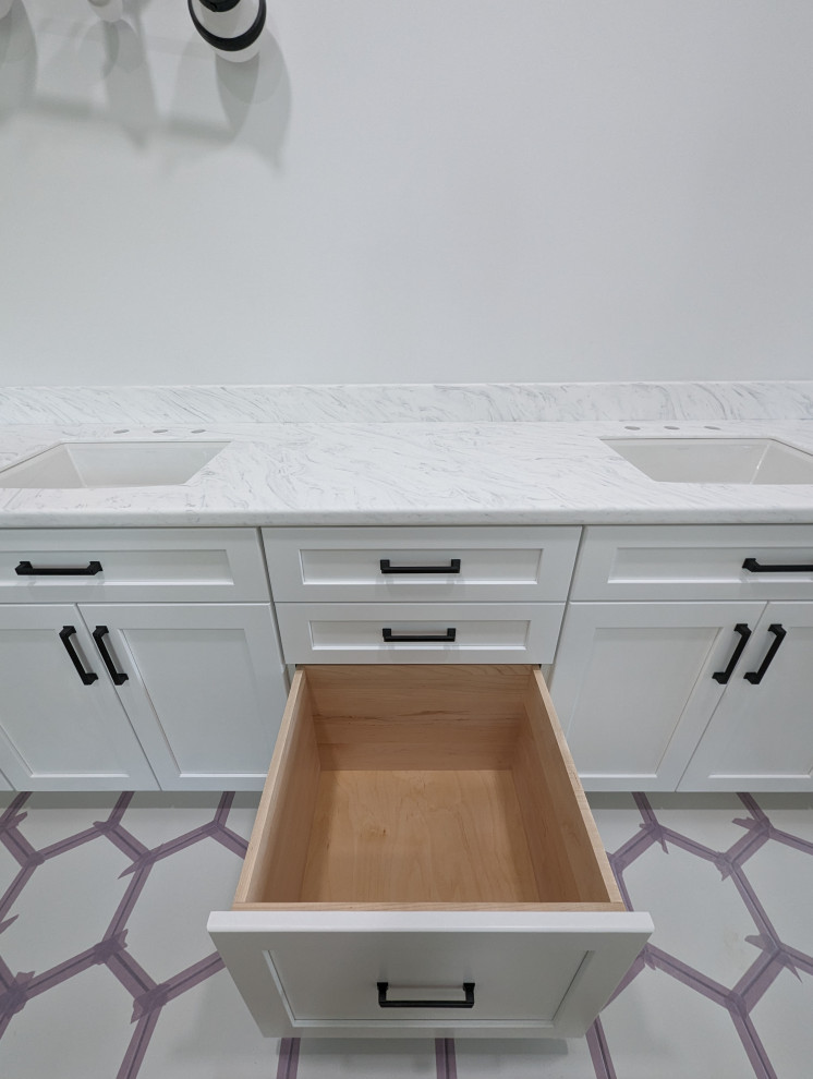 Example of a mid-sized master white floor and double-sink bathroom design with flat-panel cabinets, white cabinets, solid surface countertops, white countertops and a built-in vanity