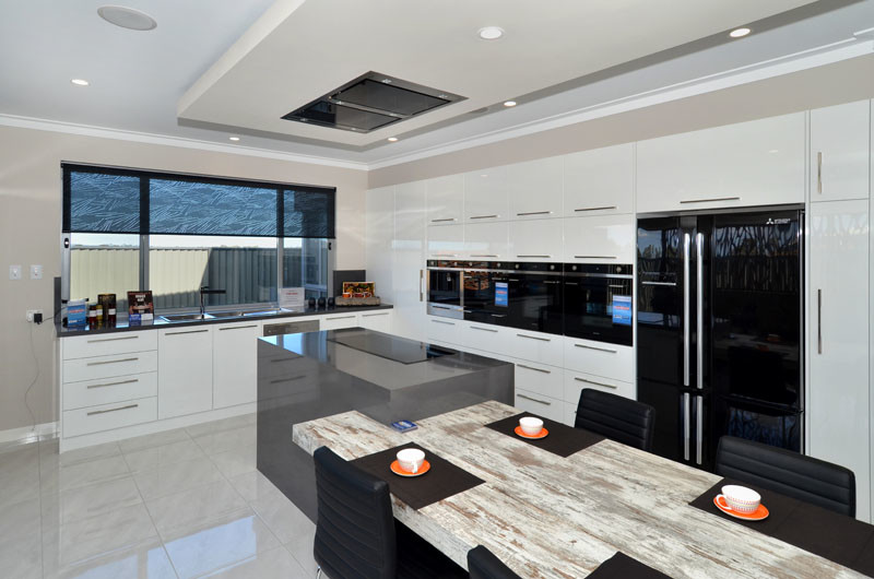 Inspiration for a large contemporary l-shaped eat-in kitchen in Other with a double-bowl sink, flat-panel cabinets, white cabinets, quartz benchtops, grey splashback, glass sheet splashback, black appliances, ceramic floors and with island.