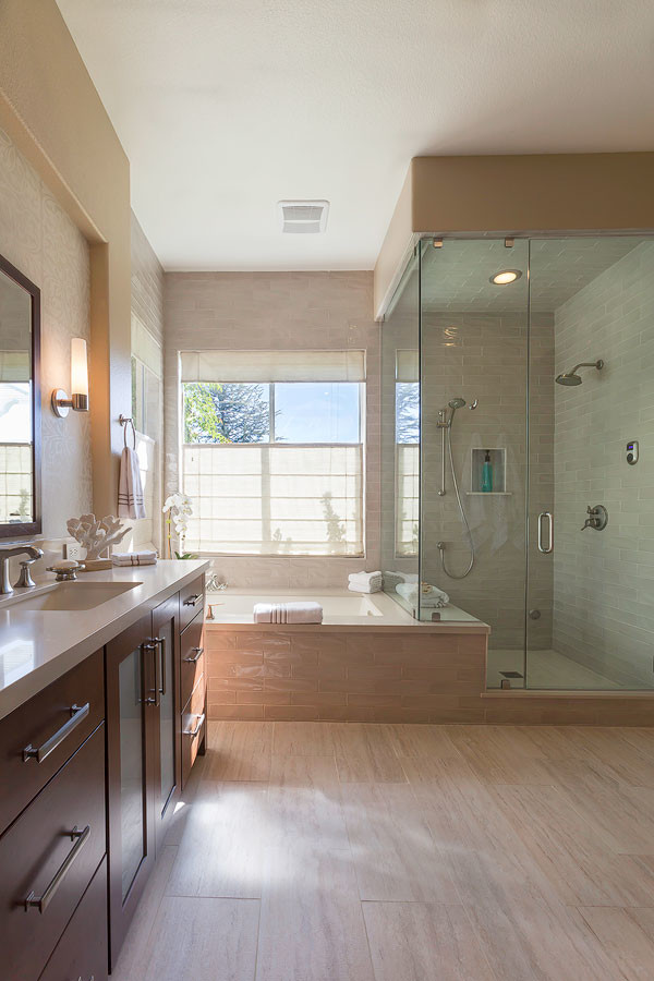 This is an example of a large beach style master bathroom in Los Angeles with an undermount sink, flat-panel cabinets, engineered quartz benchtops, a corner shower, beige tile, white tile, subway tile, dark wood cabinets, an undermount tub, white walls, vinyl floors, beige floor and a hinged shower door.