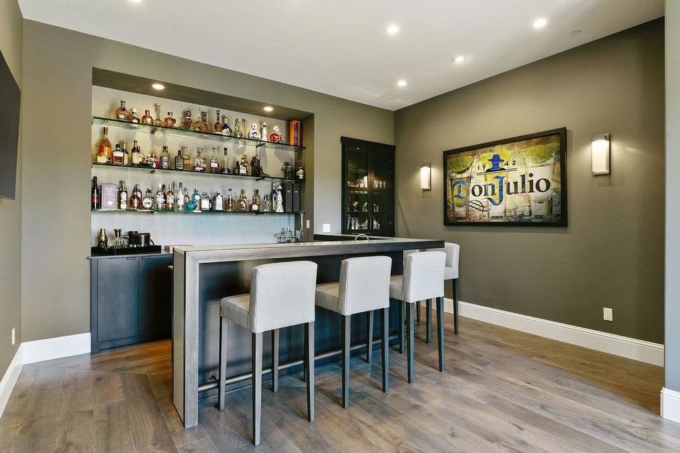 Large transitional u-shaped seated home bar in San Francisco with open cabinets, medium hardwood floors and brown floor.