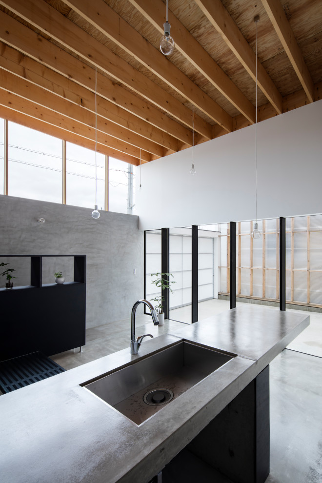 Photo of an industrial single-wall open plan kitchen in Kyoto with an undermount sink, open cabinets, black cabinets, concrete benchtops, concrete floors, grey floor and wood.