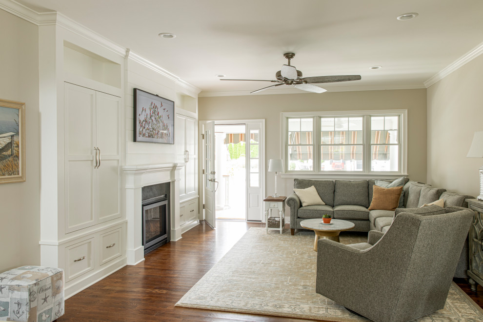 This is an example of a beach style open concept living room in New York with beige walls, medium hardwood floors, a standard fireplace, a stone fireplace surround and a wall-mounted tv.