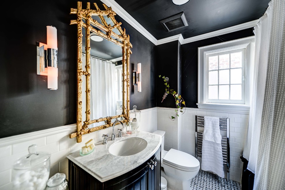Photo of a traditional bathroom in Toronto with marble benchtops, subway tile and black walls.
