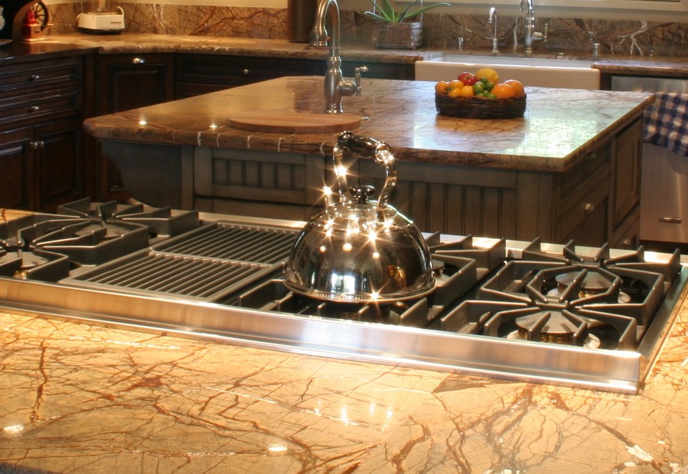 Inspiration for a large transitional u-shaped terra-cotta tile open concept kitchen remodel with a farmhouse sink, furniture-like cabinets, dark wood cabinets, granite countertops, stone slab backsplash, stainless steel appliances, white walls and an island