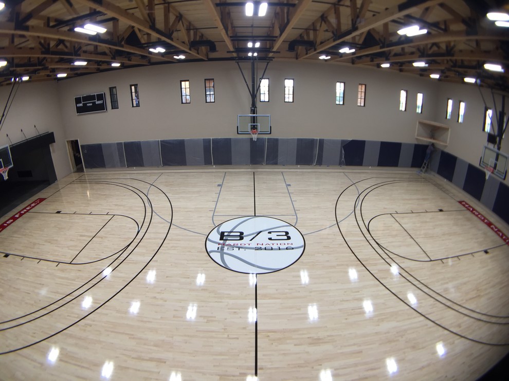 Large traditional indoor sport court in Phoenix with beige walls and light hardwood floors.