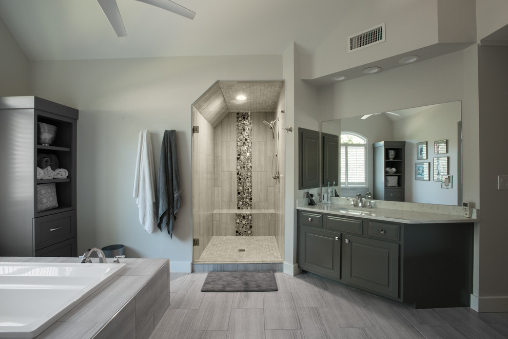 This is an example of a transitional master bathroom in Atlanta with grey cabinets.