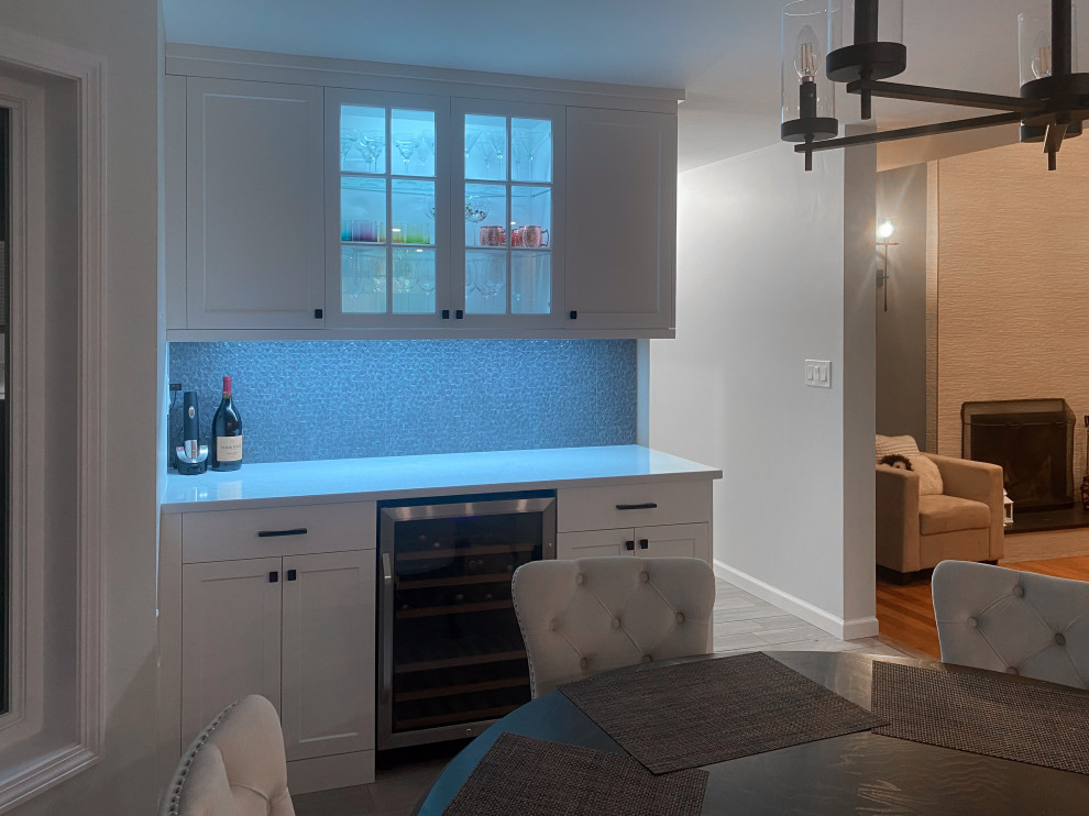 Inspiration for a large contemporary single-wall dry bar in Bridgeport with shaker cabinets, white cabinets, engineered stone countertops, grey splashback, porcelain splashback, porcelain flooring, grey floors and white worktops.