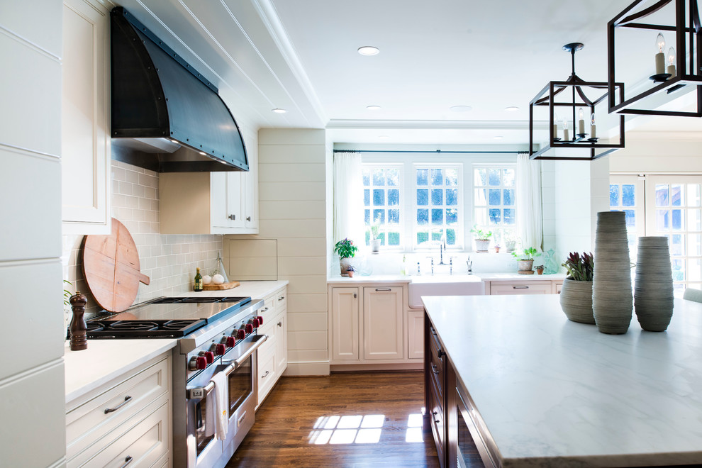 Example of a transitional medium tone wood floor open concept kitchen design in Atlanta with beaded inset cabinets, white cabinets, ceramic backsplash and an island