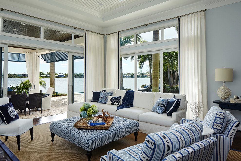 This is an example of a large beach style formal open concept living room in Miami with grey walls, dark hardwood floors, no fireplace and no tv.
