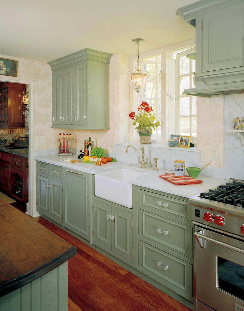 Inspiration for a traditional kitchen in Philadelphia with a farmhouse sink, beaded inset cabinets, green cabinets, white splashback, stone slab splashback and stainless steel appliances.