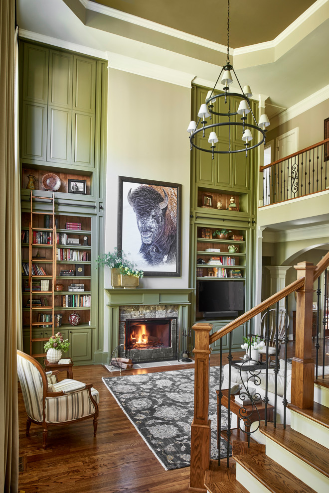 Mid-sized traditional open concept living room in Atlanta with a library, beige walls, medium hardwood floors, a wood stove, a stone fireplace surround, a built-in media wall and brown floor.
