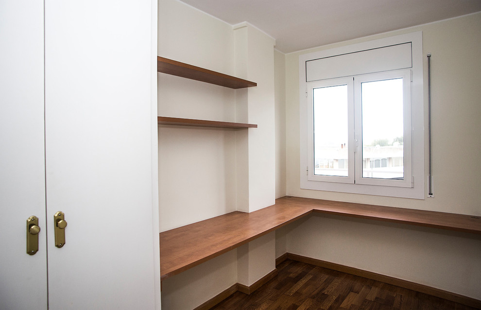 Imagen de habitación de invitados tradicional renovada de tamaño medio sin chimenea con paredes beige y suelo de madera oscura