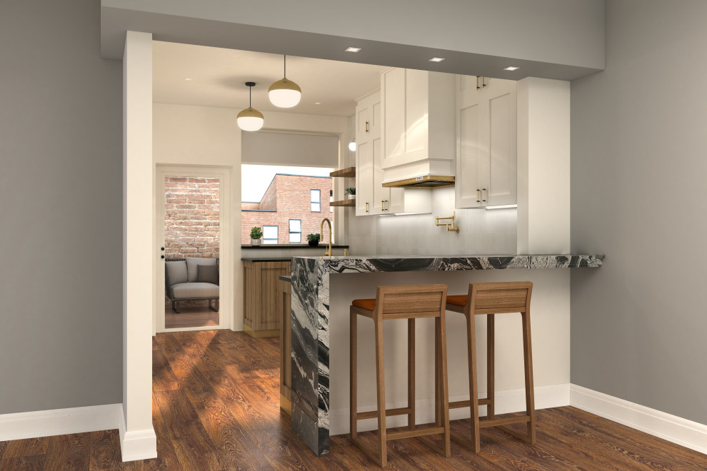 Design ideas for a mid-sized transitional galley eat-in kitchen in Chicago with an undermount sink, shaker cabinets, white cabinets, quartzite benchtops, white splashback, ceramic splashback, stainless steel appliances, medium hardwood floors, a peninsula, brown floor, black benchtop and recessed.
