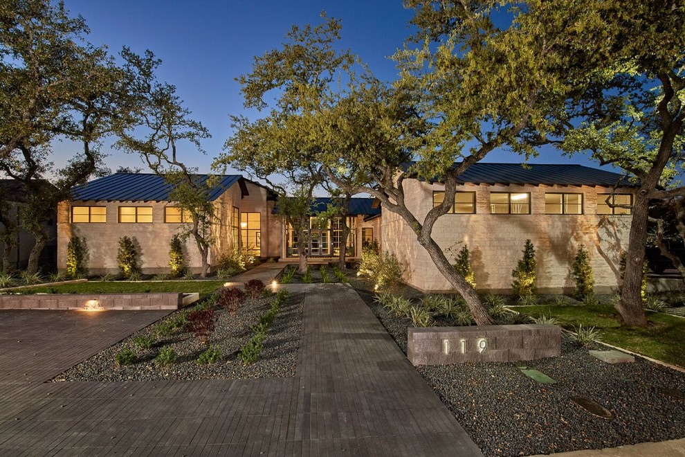 Large transitional front yard full sun garden in Austin with a garden path and natural stone pavers for spring.