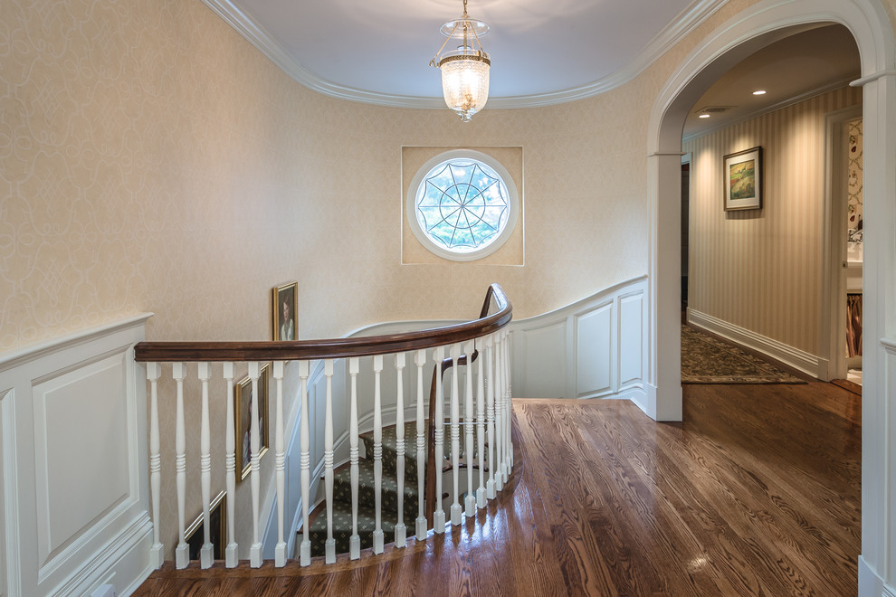 Design ideas for a large traditional carpeted u-shaped staircase in New York with wood risers and wood railing.