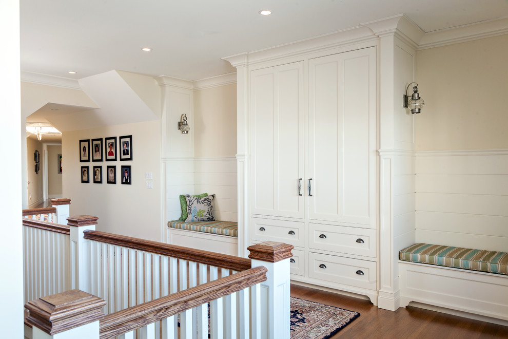 This is an example of a beach style hallway in Boston with beige walls and medium hardwood floors.