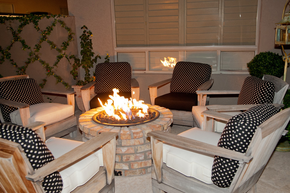 Medium sized classic back patio in Phoenix with a fire feature, concrete paving and no cover.