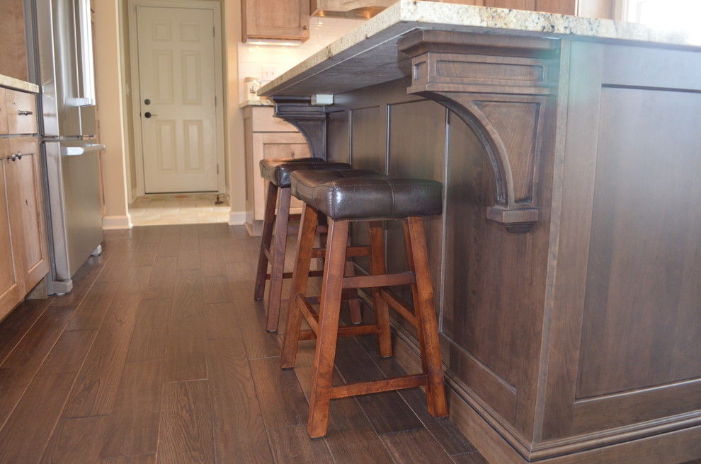 Eat-in kitchen - rustic l-shaped dark wood floor eat-in kitchen idea with an undermount sink, shaker cabinets, medium tone wood cabinets, laminate countertops, black backsplash, subway tile backsplash, stainless steel appliances and two islands